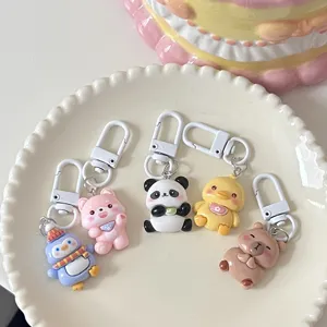 Cute cartoon animal keychains set, including panda, penguin, and duck charms for bags.