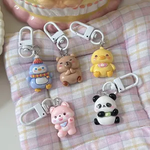 Cute cartoon animal keychains set featuring resin penguin, bear, duck, and panda bag pendants.