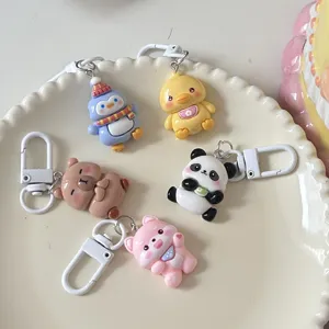 Cute cartoon animal keychain set featuring penguin, duck, bear, panda, and dog pendants.