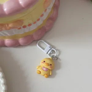 Cute yellow duck cartoon keychain detail, resin animal pendant accessory for cute style bags.
