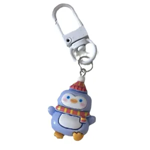 Cute cartoon penguin keychain with winter hat and scarf, adorable metal clasp pendant for keys.