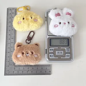 Cute plush cartoon animal keychain pendant detail view, soft rabbit and bear bag charm.