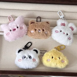 Close-up detail of cute plush animal keychains, soft fabric texture and metal clasps.