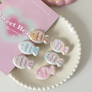 Close-up detail shot of cute pastel plaid fish hair clips showcasing the sweet design.