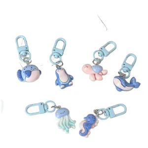 Cute ocean animal keychains set, cartoon penguin turtle whale design, stylish bag charm gifts.