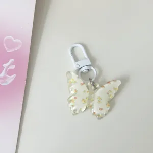 Translucent floral butterfly keychain detail, clear jelly pendant charm for bag or keys.