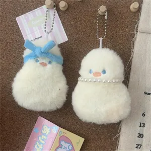Plush duck keychain detail showing fluffy texture, blue bow, and pearl necklace design.