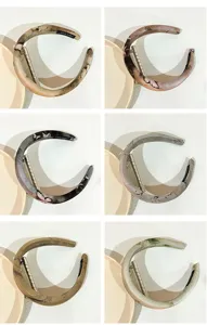 Detail view of vintage artistic fabric sponge hair hoop showing multiple color variants clearly.