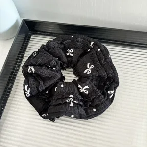 Black lace bow scrunchie hair accessory, stylish elastic hair tie for women daily wear.