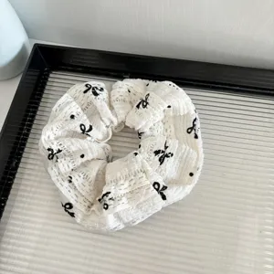 White lace bow scrunchie detail view, elegant hair accessory for women daily styling and fashion wear.