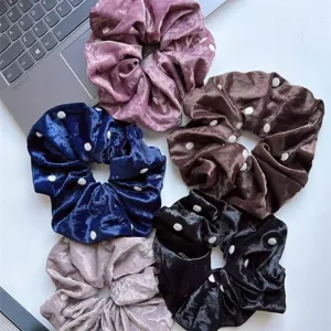 Detailed shot of soft velvet polka dot hair scrunchies in multiple elegant colors for women.