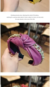Close-up detail of stylish purple leather knotted headband featuring chunky gold chain design.