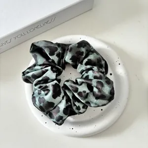 Green leopard print satin scrunchie detail view, soft hair tie for women daily use