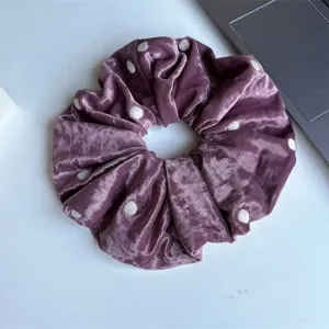 Large velvet hair scrunchie in elegant purple with white polka dots for everyday hair styling.