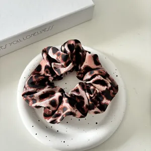 Retro leopard print satin hair scrunchie for women, elegant wide elastic hair band accessory.