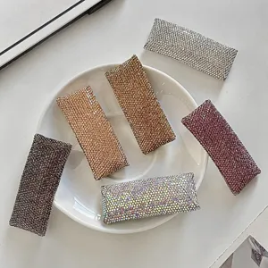 Detailed view of rhinestone hair clips, sparkling crystal bobby pins in various colors.