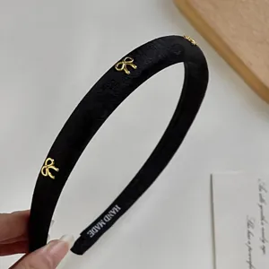 Retro dark totem bow fabric headband detail, exquisite gold bow accents and handmade label.