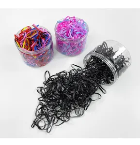 Disposable elastic hair rubber bands in clear jars, colorful small hair ties for styling.