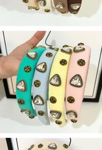 Wide fabric headband with vintage metal studs and crystal rhinestones, vibrant colors.