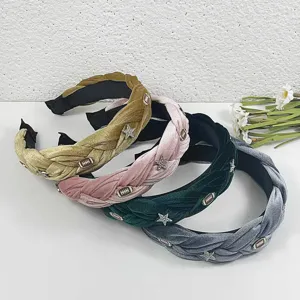Detailed close-up of velvet braided headbands featuring sparkling rhinestone stars and chic charms.