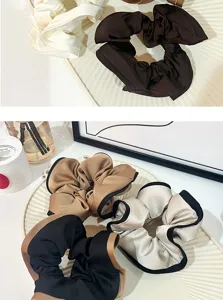Detail view of stylish satin hair scrunchies with contrast edges, soft texture for daily wear.