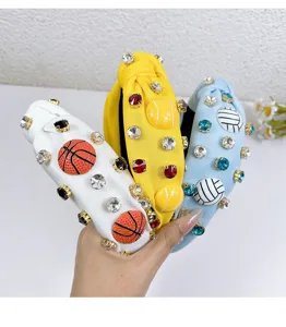 Detailed close-up of sparkling rhinestone knotted headbands with fun sports ball charms.
