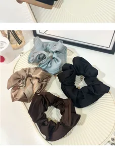 Detailed close-up view of stylish satin hair scrunchies in multiple classic colors for women.