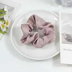 Elegant silk satin hair scrunchie in dusty pink, perfect for stylish everyday ponytails.