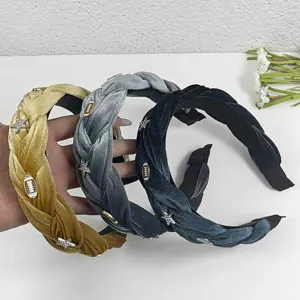 Detailed view of wide velvet braided headbands with sparkling star rhinestone charms.