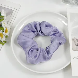 Purple satin hair scrunchie detail view, elegant shiny hair tie for daily fashion styling.