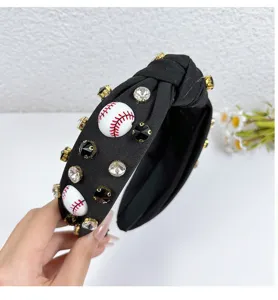 Close-up of black fabric knotted headband decorated with crystals and baseball charms.