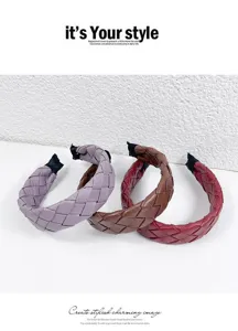 Close-up of the stylish woven leather headband, highlighting exquisite handmade braided texture.