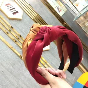 Stylish wide fabric knotted headband for women, comfortable satin hair hoop accessory.