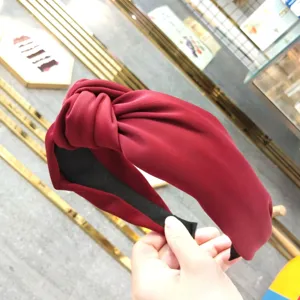 Wide red fabric knotted hair hoop for women, stylish solid color vintage hair accessory.