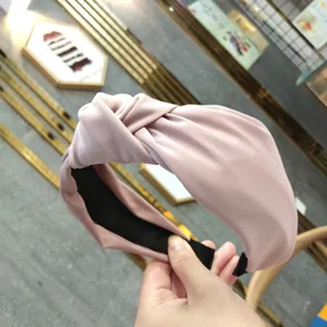Pink fabric knotted headband for women, wide brim hair hoop, elegant hair accessory.