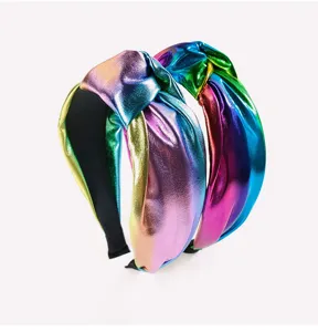 Detailed view of trendy metallic rainbow knotted headbands featuring a shiny wide design.