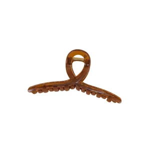 Large amber acrylic hair claw clip for women, stylish twisted design shark hair clip.