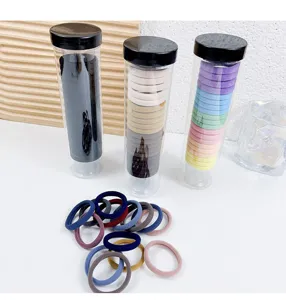 Buntes Set aus elastischen Haargummis mit transparenten Aufbewahrungsrohren für Frauen.