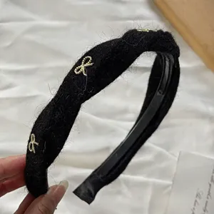 Knitted plush twisted headband detail, featuring elegant gold bow alloy accessory.