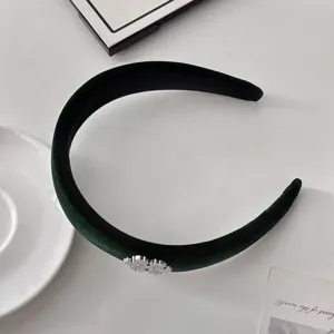Dark green velvet headband featuring a sparkling rhinestone snowflake charm for women.