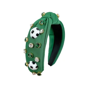 Green knotted headband decorated with sparkling rhinestones and cute soccer ball charms.