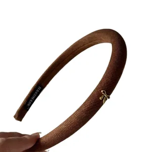 Brown fabric headband with cute gold bow accessory, stylish retro hair hoop for women.