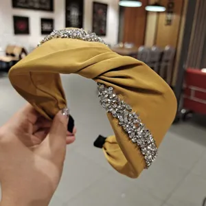 Stylish mustard yellow satin knotted rhinestone headband, elegant wide hair hoop accessory.