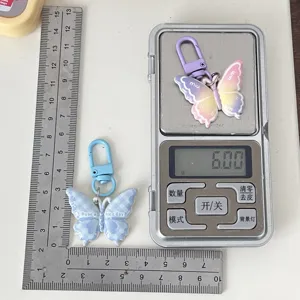 Detailed view of the colorful butterfly keychain showing its compact size and light weight.