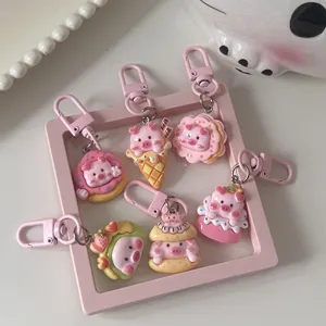 Cute dessert pig keychains detailed view, soft pink resin charms set for kawaii bag accessories.