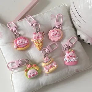 Cute cartoon piggy food play keychains, pink sweet dessert resin pendant charms detail shot.