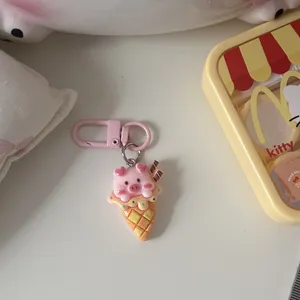 Cute pink pig ice cream cone keychain detail view, soft cartoon pendant showing close up.