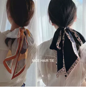 Detail view of long silk hair ribbon, stylish double-layer printed design for ponytail.