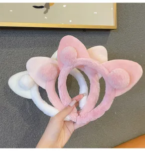 Fluffy cat ear headband detail, soft plush material with cute pompom for winter wear.