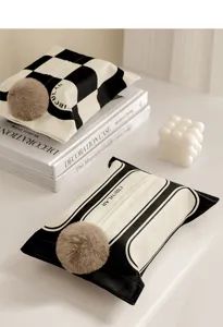Detailed view of French style black and white fabric tissue box cover with cute plush ball decor.